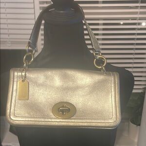 Coach Gold Metallic Shoulder Bag with Turnlock Closure and Striped Strap